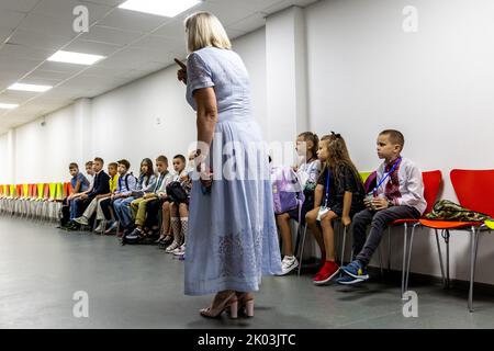 Children receive a training in a bomb shelter from a teacher how to behave during the siren alarm as they attend the opening day of school year in a famous Black Sea resort of Odessa, Ukraine on September 1, 2022. Children get back to school as the country surpasses 6 months after the Russian invasion. Only those schools that have save bomb shelters will open. Only a small percentage of children in the Odessa region physically get back to school, most of the children will continue to learn online. (Photo by Dominika Zarzycka/Sipa USA) Stock Photo