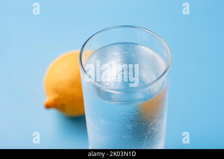 A Glass of Cold Water with Ice and Lemon on a Blue Background Stock Photo -  Image of isolated, object: 148203114