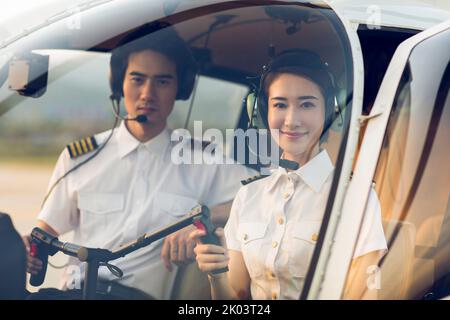 Chinese pilots sitting in helicopter cockpit Stock Photo