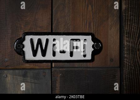 Metal plate with wi-fi sign  on vintage wooden wall Stock Photo