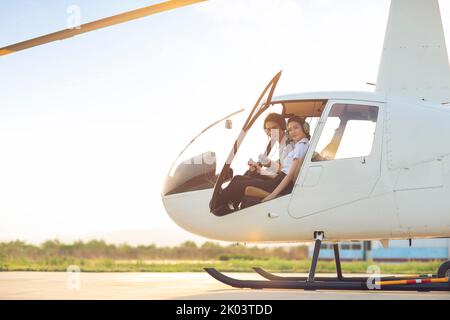 Chinese pilots sitting in helicopter cockpit Stock Photo