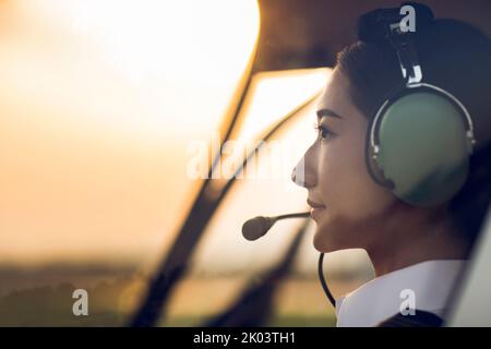 Chinese pilot sitting in helicopter cockpit Stock Photo