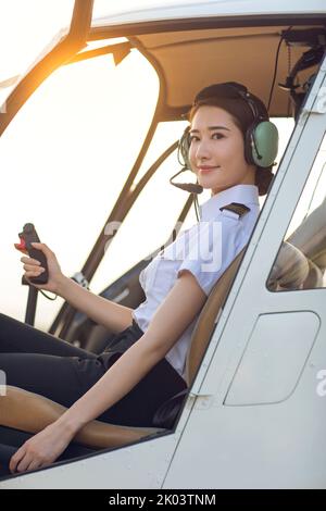 Chinese pilot sitting in helicopter cockpit Stock Photo