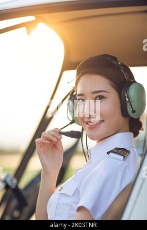 Chinese pilot sitting in helicopter cockpit Stock Photo