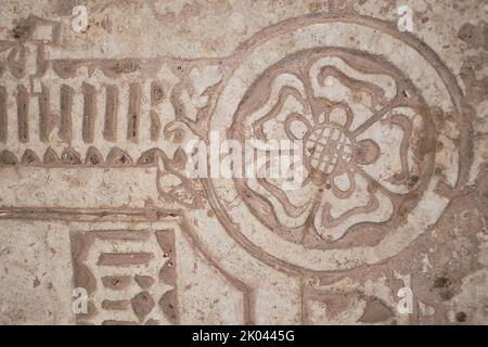 Stone Roses Symbols Carved symbol of a five-petaled rose with a globe on a stone tomb slab ...