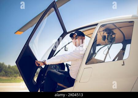 Chinese pilot sitting in helicopter cockpit Stock Photo