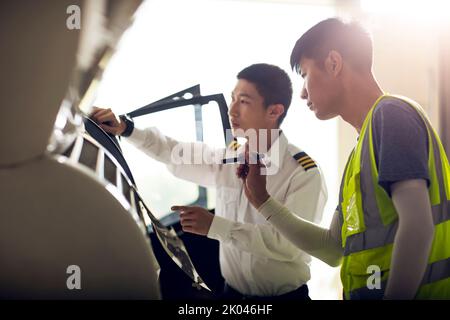 Chinese airplane mechanic checking helicopter Stock Photo