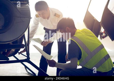 Chinese airplane mechanic checking helicopter Stock Photo