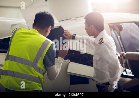 Chinese airplane mechanic checking helicopter Stock Photo