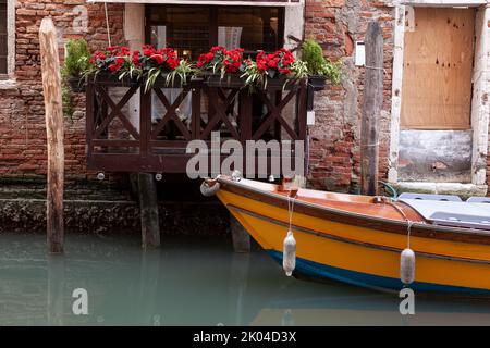 Typical wooden boat in the Venice canal, Italy Stock Photo