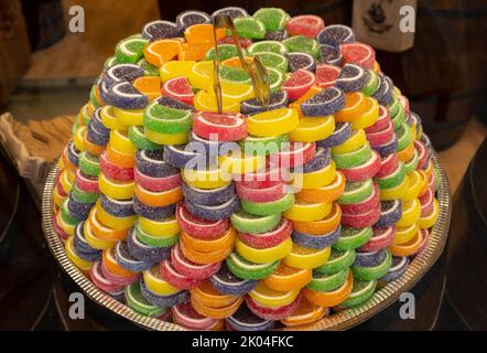 Macaron candies on display in the showcase. Colorful, sour patch candies or macarons. selective focus. Stock Photo