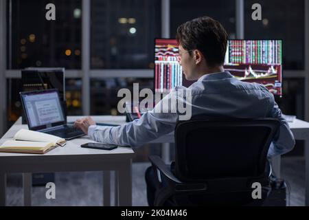 Chinese businessman working in office at night Stock Photo