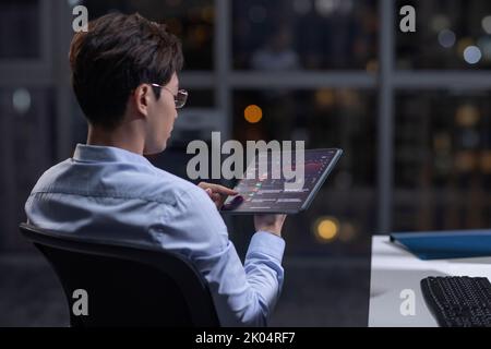 Chinese businessman working in office at night Stock Photo