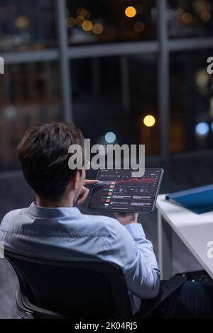 Chinese businessman working in office at night Stock Photo