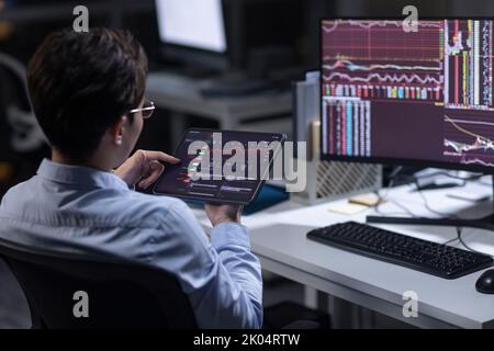 Chinese businessman working in office at night Stock Photo