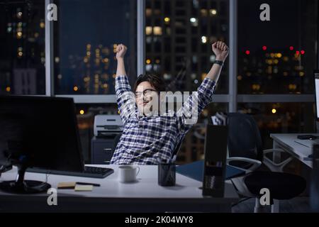 Chinese IT worker working in office at night Stock Photo