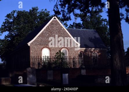 Petersburg, VA. USA. 9/1993.  Blandford Church or St. Paul’s Church or The Brick Church.  Built circa 1736 on Wells Hill.  Fifteen windows were installed between 1904 and 1912. Most display a state seal, the figure of a saint, and an inscription. Eleven were donated by each of the former Confederate states.  One stained glass window of a Christian cross of jewels donated by Louis Comfort Tiffany.  The church building was abandoned in 1806.  During the Civil War the church served as a major telegraph station. It was used as a field hospital, most notably after the Battle of the Crater. Stock Photo