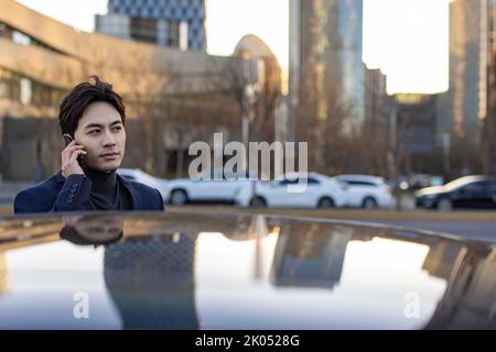 Chinese businessman talking on cell phone Stock Photo