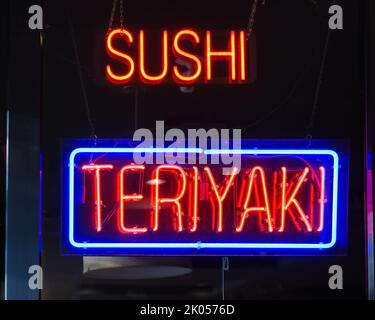 Neon window sign for Sushi and Teriyaki in close up Stock Photo