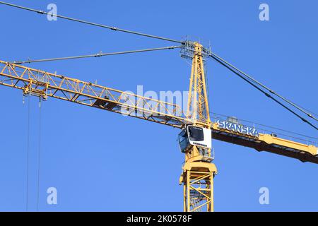 Bellevue, WA, USA - September 08, 2022; Skanska crane cab and structure isolated against blue sky Stock Photo