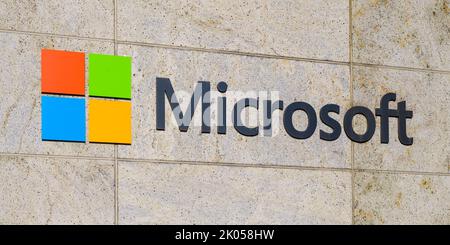 Bellevue, WA, USA - September 08, 2022; Sign for Microsoft Corporation with logo on stone tile wall Stock Photo