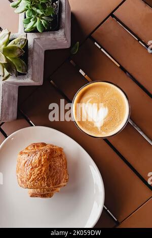 Flat white coffee and chocolate puff pastry, top view Stock Photo