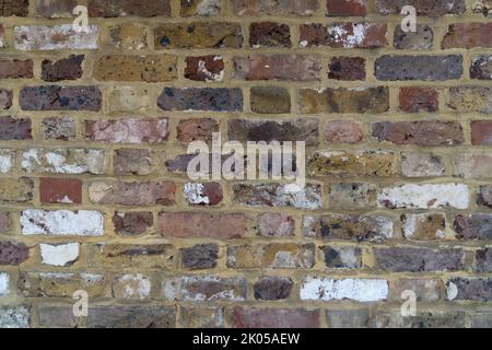 Close up stone wall several colored bricks exactly laid bricked laid brick as background and concept for bricks buildings and build old buildings wall Stock Photo