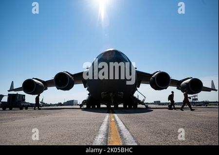 Airmen assigned to the 732nd Airlift Squadron and the 111th Operations Group enter a C-17 Globemaster on Joint Base McGuire-Dix-Lakehurst, N.J., Aug. 24, 2022. Airmen from the 111th OG, Tactical Air Control Party specialists from the 148th Air Support Operations Squadron, and members of the 305th Air Mobility Wing, and its associate reserve unit, the 514th Air Mobility Wing, took part in a two-part joint exercise that included the integration of the MQ-9 Reaper’s ability to support ground troops and coordinate support for a C-17 Globemaster III flying over hostile territory at training at Fort Stock Photo