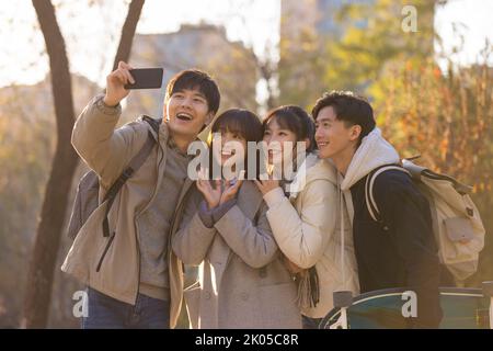 Happy Chinese college students taking selfie on campus Stock Photo