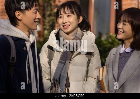 Happy Chinese college students talking on campus Stock Photo