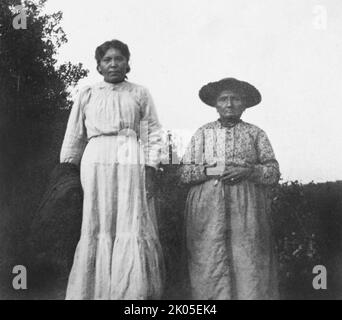 Two mature Native American women stand for a portrait in Northern Wisconsin, ca. 1920. Stock Photo