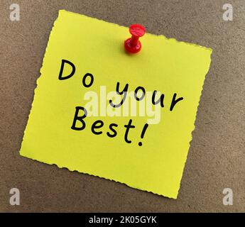 Do your best text on yellow notepad with wooden background. Motivational concept. Stock Photo