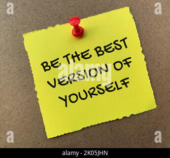 Be the best version of yourself text on yellow notepad with wooden background. Motivational concept. Stock Photo