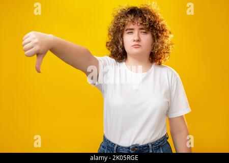 dislike sign overweight bullying woman thumb down Stock Photo