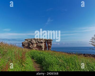 The Path or Trail leading down the Fife Coastal Path towards Buddo Rock, a Sandstone Arch located on a Raised Beach at Buddo Ness. Stock Photo