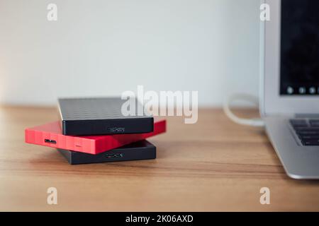Hard Drives for data storaage stacked on a Desk Stock Photo
