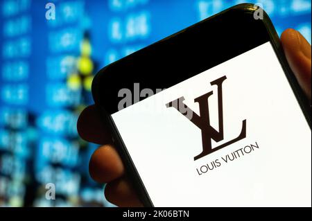 In this photo illustration, the French luxury fashion brand Louis Vuitton (LV) logo is displayed on a smartphone screen. Stock Photo