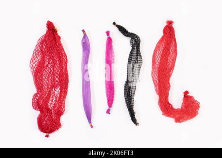 Group of empty plastic net bags isolated on white background. Food packaging industry. Plastic disposable waste Stock Photo