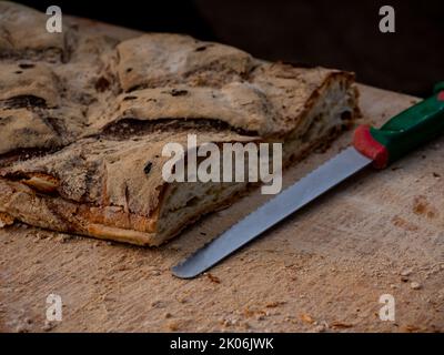 close-up shot knife with cut bread on a table Stock Photo