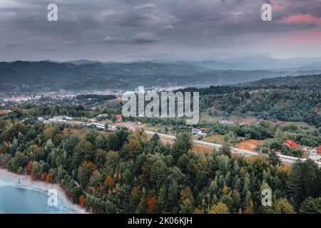 Tranquil mountains view on a cloudy evening in autumn—dense forest and sunset sky on the Carpathian Mountains. Stock Photo