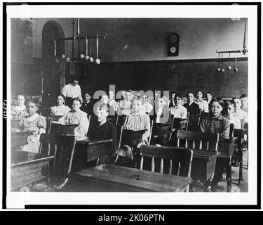 Boys and girls seated at desks in Washington, D.C. classroom, (1899?). Stock Photo