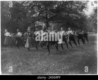 Classroom scenes in Washington, D.C. public schools - outdoor exercise with rods - 3rd Division, (1899?). Stock Photo