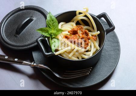 Pici pasta with Bolognese sauce in pots, pasta, pasta Stock Photo