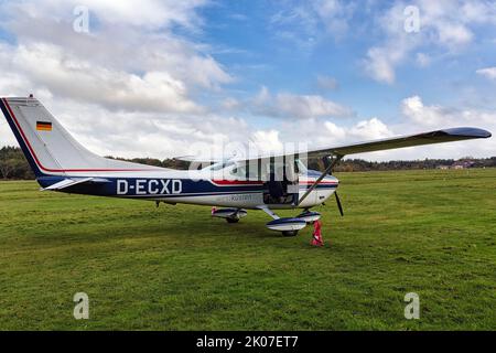 Cessna, light aircraft stands by on grass field at airport, Wyk airfield, Wyk auf Foehr, Foehr island, North Frisia, Schleswig-Holstein, Germany Stock Photo