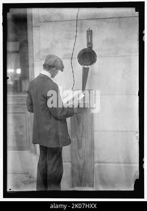 Young man standing near speaker, between 1910 and 1917.  'Manufactured by The Magnaphone Co. New York City. Patented'. Stock Photo