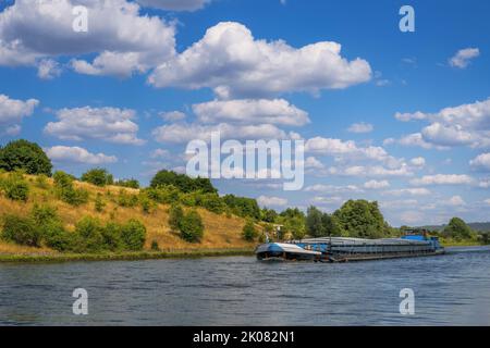 Barge on the Rhine–Main–Danube Canal in an idyllic valley (Bavaria, Germany) Stock Photo