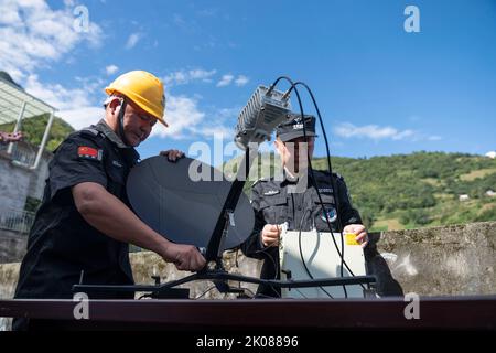 Ya'an, China's Sichuan Province. 10th Sep, 2022. Technician Liao Hua (L) installs a portable satellite station with his colleague in Xingfu Village of Shimian County, Ya'an City, southwest China's Sichuan Province, Sept. 10, 2022. Credit: Cai Yang/Xinhua/Alamy Live News Stock Photo