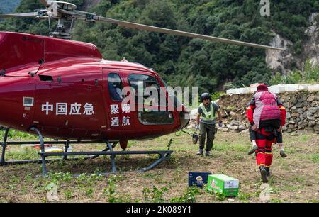 Ya'an, China's Sichuan Province. 10th Sep, 2022. Rescuers transfer a sick elder woman in Xingfu Village of Shimian County, Ya'an City, southwest China's Sichuan Province, Sept. 10, 2022. Credit: Cai Yang/Xinhua/Alamy Live News Stock Photo