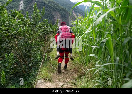 Ya'an, China's Sichuan Province. 10th Sep, 2022. A rescuer transfers a sick elder woman in Xingfu Village of Shimian County, Ya'an City, southwest China's Sichuan Province, Sept. 10, 2022. Credit: Cai Yang/Xinhua/Alamy Live News Stock Photo