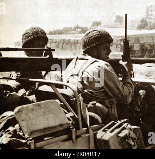 Patrol jeep carrying a recoilless rifle moves into a town during the 1948 (or First) Arab-Israeli War, the second and final stage of the 1947-1949 Palestine War. It formally began following the end of the British Mandate for Palestine at midnight on 14 May 1948; the Israeli Declaration of Independence had been issued earlier that day, and a military coalition of Arab states entered the territory of British Palestine in the morning of 15 May Stock Photo